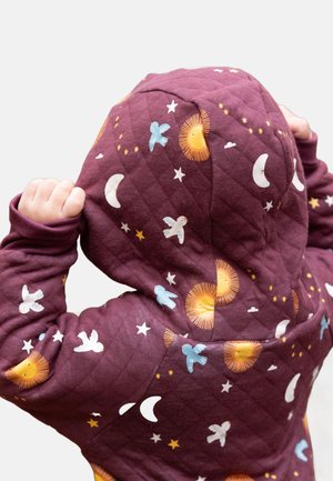 Quilted maroon hoodie with a hood, featuring a pattern of suns, moons, stars, and birds in various colors. Soft texture and comfortable fit.
