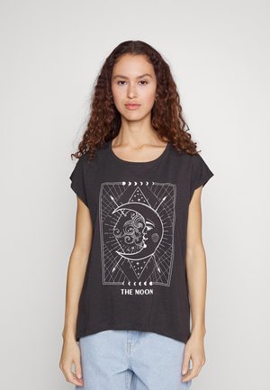 Dark gray t-shirt with a relaxed fit, featuring a white graphic of a moon and face design, outlined with geometric patterns and text "THE MOON."