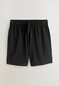 Shorts à taille élastique noire avec cordon réglable et poches latérales, étalés à plat sur un fond clair.