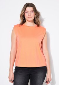 Mouwloze top in levendig koraal, met een ronde halslijn en zachte jersey stof. De zoom is recht en zit op de taille.