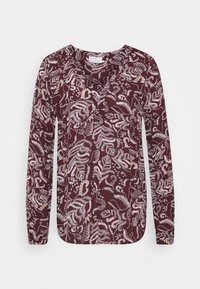 Långärmad bordeauxblus med ett vitt blommönster, V-ringning och rak nederkant. Tillverkad av lätt, texturerad tyg.