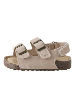 Beežidest seemisnahast sandaal kahe reguleeritava pandlaga rihmaga, takjakinnitusega pahkluurihmaga ja tekstuursepruuni tallaga.