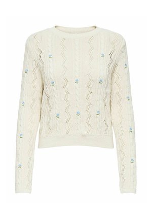 Pull en tricot crème avec un motif en zigzag texturé et des détails de broderie florale bleue. Dispose d'un col rond et de manches longues.