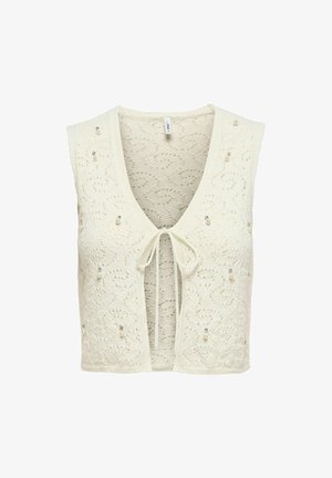 Knit cropped vest in cream with a deep V-neck, tie closure, and decorative bead detailing. Features a textured floral pattern throughout.