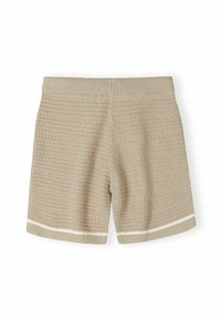 Short en tricot beige avec taille côtelée et bord blanc près de l'ourlet, présentant une couture horizontale texturée sur toute la surface.