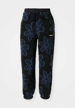 Fleece joggers with a black background and dark blue floral pattern. Features an elastic waistband and side pockets. Soft texture.