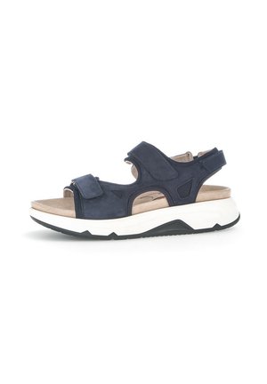 Sandali in suede blu navy con cinturini in velcro, apertura davanti, soletta beige imbottita e suola spessa in gomma bianca con dettagli neri.