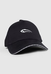 Black baseball cap with a curved brim, featuring a white logo on the front and a patterned black and white trim along the underside.