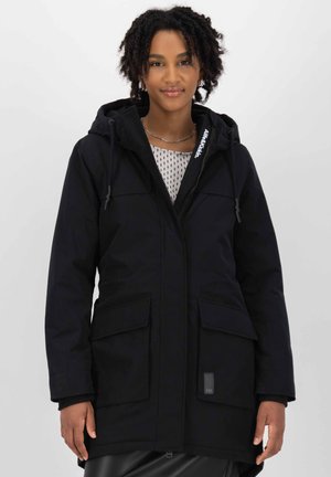 Black parka jacket with a zip front, adjustable hood, front flap pockets, and textured fabric. Features a logo on the collar.