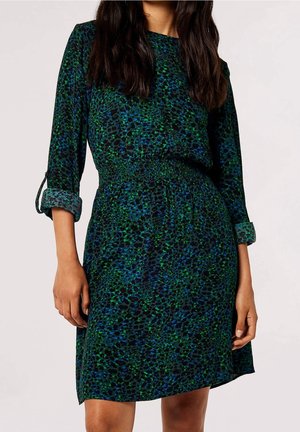 Robe à motifs verts et bleus avec une taille froncée, des manches longues et des poignets retroussés. Fabriquée dans un tissu léger à la texture lisse.