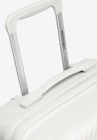 Weißer Koffer mit strukturierter Außenseite, silbernem Teleskophandgriff und Oberhandgriff. Verfügt über einen Reißverschluss und eine Markenakzent.