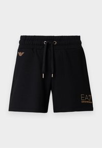 Fekete pamut rövidnadrág elasztikus derékpánttal és húzózsinórral. Arany logós felirat és díszítések találhatók az elején. Két oldalzsebbel.