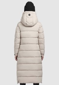 Beige puffer coat with a hood, featuring horizontal quilted sections, elastic cuffs, and a logo detail on the back.