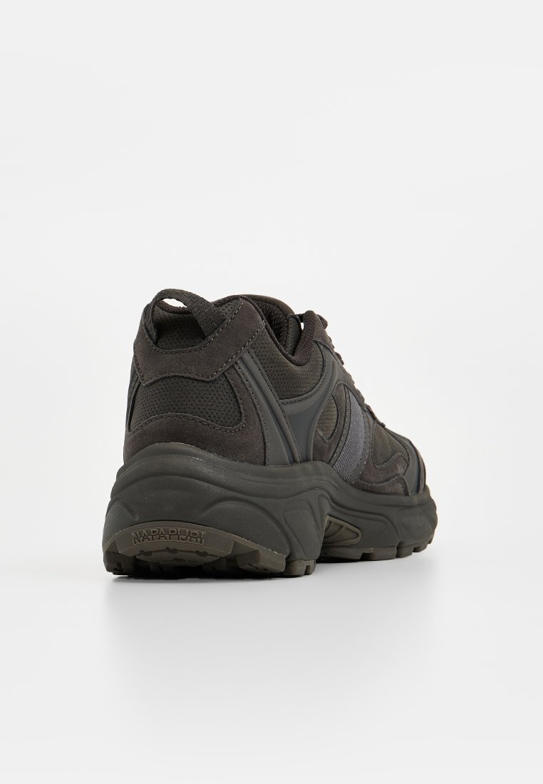 Zapatillas deportivas de color gris oscuro con parte superior de ante texturizado y malla. Suela de goma gruesa y diseño curvado con una marca sutil en el talón.