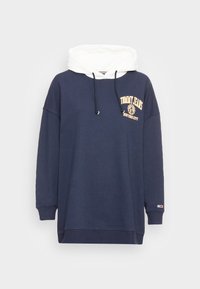 Námořnický pulovrový svetr s bílou kapucí, s logem a textem na hrudi, nastavitelnou šňůrkou, volným střihem a žebrovanými manžetami.