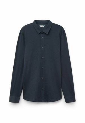 Chemise à manches longues bleu marine foncé en laine mérinos, avec un col, une fermeture à bouton sur le devant, et des poignets avec une texture douce.