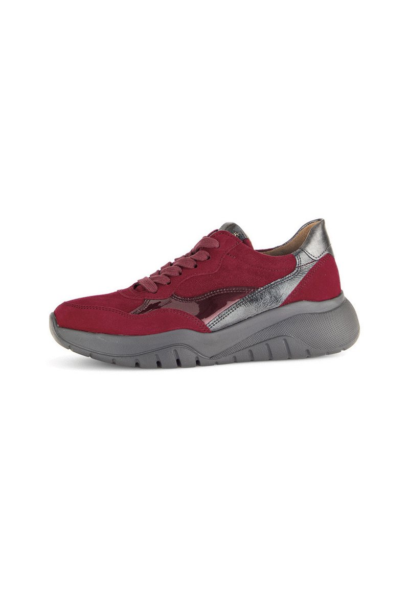Red suede sneaker with silver accents and a textured grey sole. Features a lace-up front and a sleek, rounded design.