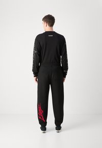 HUGO DLOGOPANTE - Spodnji deli trenirk - black