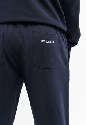 Tume puuvillane särkadega suurusega püksid kahe tagataskuga; seljale on brodeeritud "ICE ICEBERG" logo. Mugavuse ja sobivuse nimel elastne vöökoht.