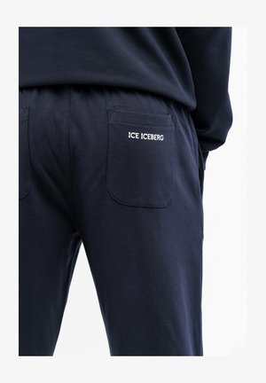 Pantalones de chándal de algodón en color marino con dos bolsillos traseros; cuenta con el logo bordado "ICE ICEBERG". Cintura elástica para mayor comodidad y ajuste.