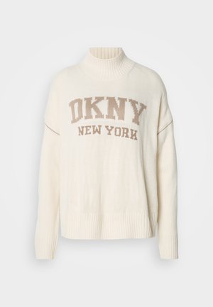 Krémový svetr s žebrovaným rolákem, s pleteným nápisem "DKNY NEW YORK" v béžové barvě. Oversized střih se žebrovanými manžetami a lemem.