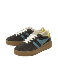 Baskets en suède marron foncé avec des rayures bleues, des lacets blancs et des accents jaunes. Elles disposent d'une épaisse semelle en caoutchouc marron avec un profil texturé.