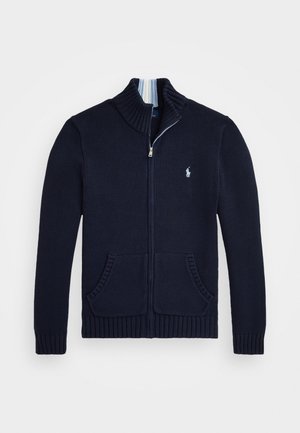 Navy sweater with high collar, full zipper, ribbed cuffs, and two front pockets. Features a small embroidered logo on the chest.