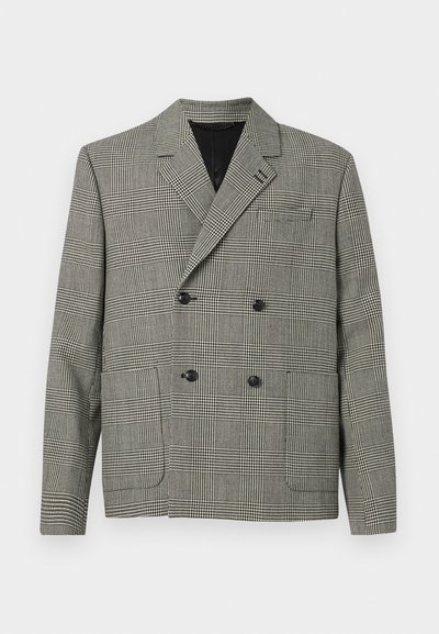 Blazer croisé à motif à carreaux noir et blanc, avec un col cranté, deux poches avant et des accents de boutons noirs.
