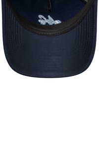 Navy baseball cap with a black brim, featuring white embroidery on the inner lining and a smooth fabric texture.