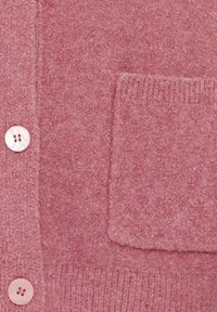 Pink knitted cardigan with a textured finish, featuring a front pocket and pearlescent buttons. Soft fabric and ribbed hem detail.