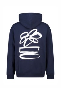 Marineblauwe hoodie gemaakt van zachte katoen. Heeft een grote witte bloemafbeelding en horizontale lijnen op de achterkant. Voorzien van een capuchon en geribbelde manchetten.