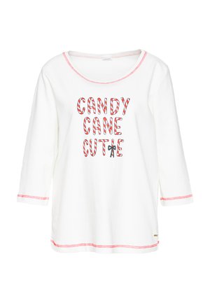White long-sleeve shirt with red stitching and text "CANDY CANE CUTIE" in red and white candy cane stripes, with a small bow on the letter E.
