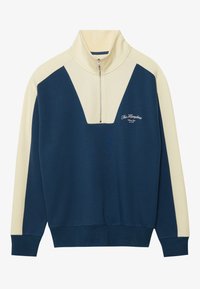 Pullover navy e crema con colletto alto, chiusura a metà zip e design a V in contrasto. Presenta un dettaglio logo ricamato sul petto.