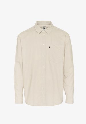 Bež pika pika särkk, millel on krae, peen vertikaalne triibumuster ja rinna tasku. Kujundatud lõdva istumisega.