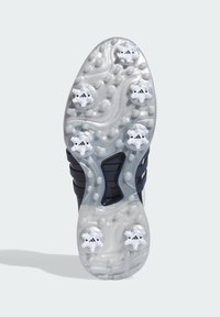 Sole sportovní boty s průhledným designem, šesti bílými hroty a texturovanými vzory pro trakci. Hlavně námořnická modř s průhlednými akcenty.