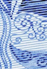 Blue and white patterned fabric featuring swirling designs and horizontal stripes, showcasing a knitted texture and various shades of blue.