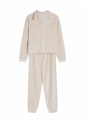 Light beige loungewear set featuring a long-sleeve top with a collared neck and elastic cuffed pants, made from soft textured fabric.