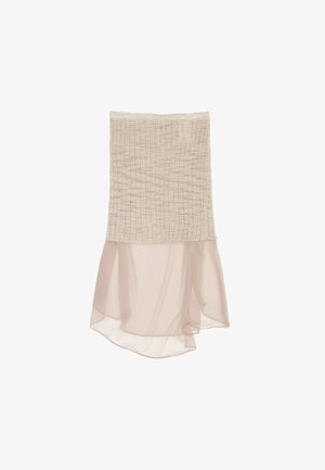 Bežist kaheosaline seelik, millel on tekstuuriga, rikutud ülemine osa ja voolav, läbipaistev šifoonist alumine osa, mis langeb asümmeetrilise äärisega.