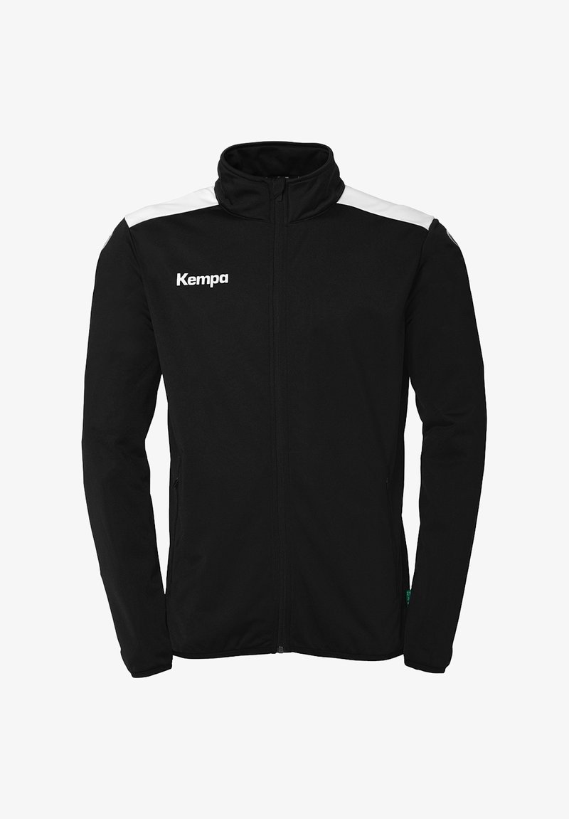 Zwarte sportjack met volledige ritssluiting, hoge kraag, witte schouderaccenten en een "Kempa" logo aan de linkerkant.