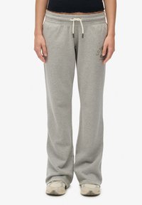 Gray sweatpants made of soft fabric, featuring a relaxed fit, elastic waistband with drawstring, and subtle branding on the left thigh.