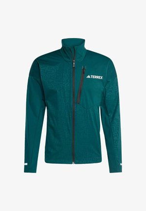 Zelená bunda na zip s vysokým límcem, texturované vzory na levé straně a náprsní kapsa s černým zipem. Zobrazené logo "TERREX".