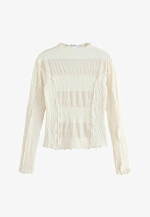 Langærmet, crèfartet sweater med tekstureret stof, der har vandrette riller og bølgede kanter. Blødere udseende med en let stræk.