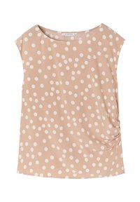 Beige top met korte mouwen van zacht materiaal, met witte stippen en een gerimpeld detail aan de zijkant voor extra textuur.