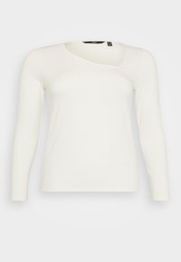 Geribbelde lange mouw top in off-white, met een ronde hals en een asymmetrisch ontwerp. Zachte textuur, aansluitende vorm en lichtgewicht materiaal.