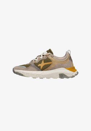 Athletic sneaker in beige, olive green, and mustard with textured sole, lace-up front, and side star-shaped logo on neutral background.