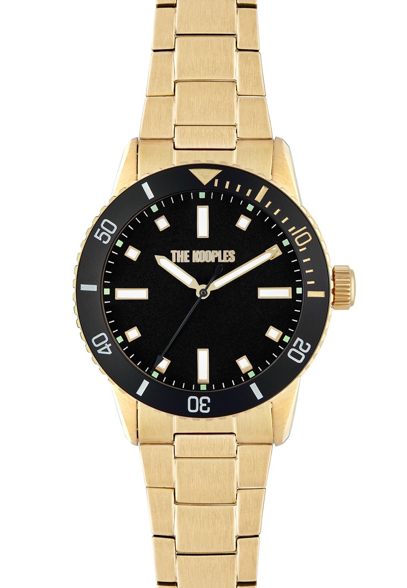 Reloj de pulsera de metal dorado con una esfera negra, marcadores de horas blancos y verdes, y un bisel unidireccional. Nombre de la marca visible a las 12 en punto.