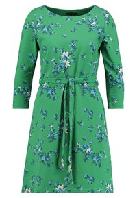 Zelené šaty s dlouhými rukávy, květinovým potiskem v bílé a modré, kulatým výstřihem a vyvazovací páskem v pase. Vyrobené z měkké látky.