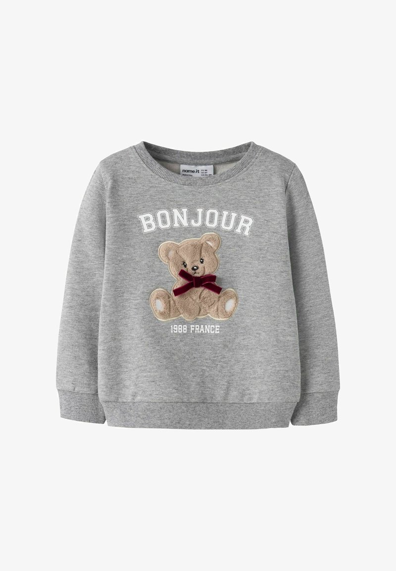 Šedá mikina s dlouhými rukávy, na které je vyšitá grafika medvěda, červená mašle a text "BONJOUR 1988 FRANCE" v bílé barvě.