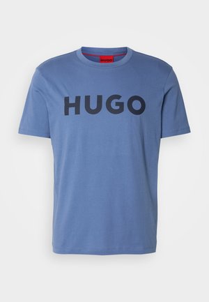 Blue cotton t-shirt with short sleeves and round neck, featuring a bold black "HUGO" logo across the chest. Smooth texture.