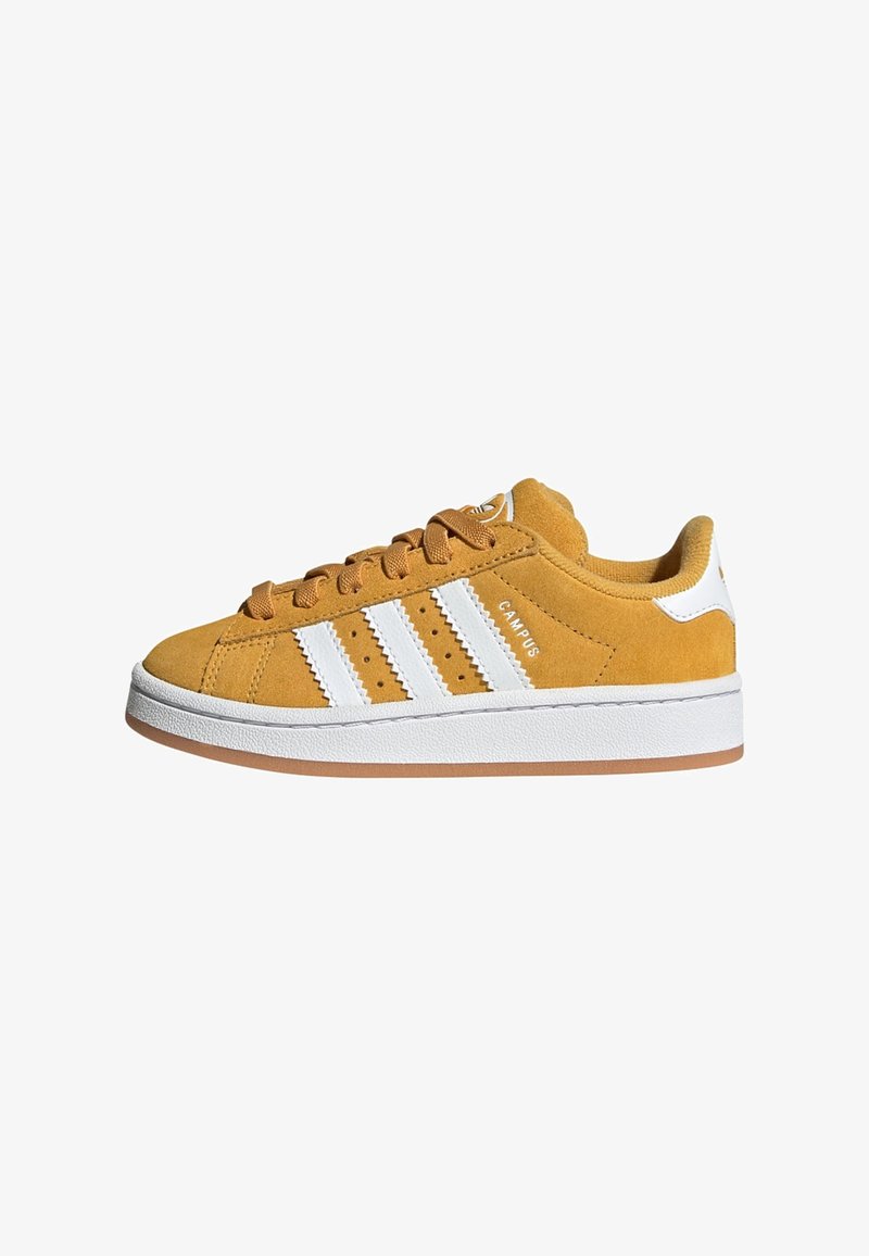 Yellow suede sneaker with white stripes, round toe, lace closure, and a rubber sole. Features perforations for ventilation and padded collar.